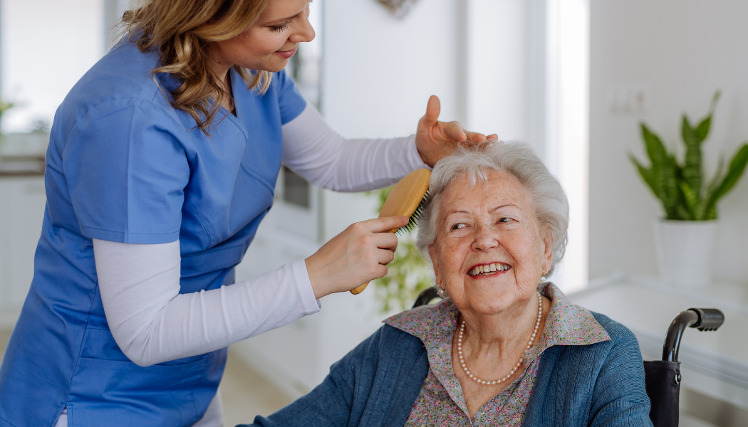 Young nurse smiling with elderly woman