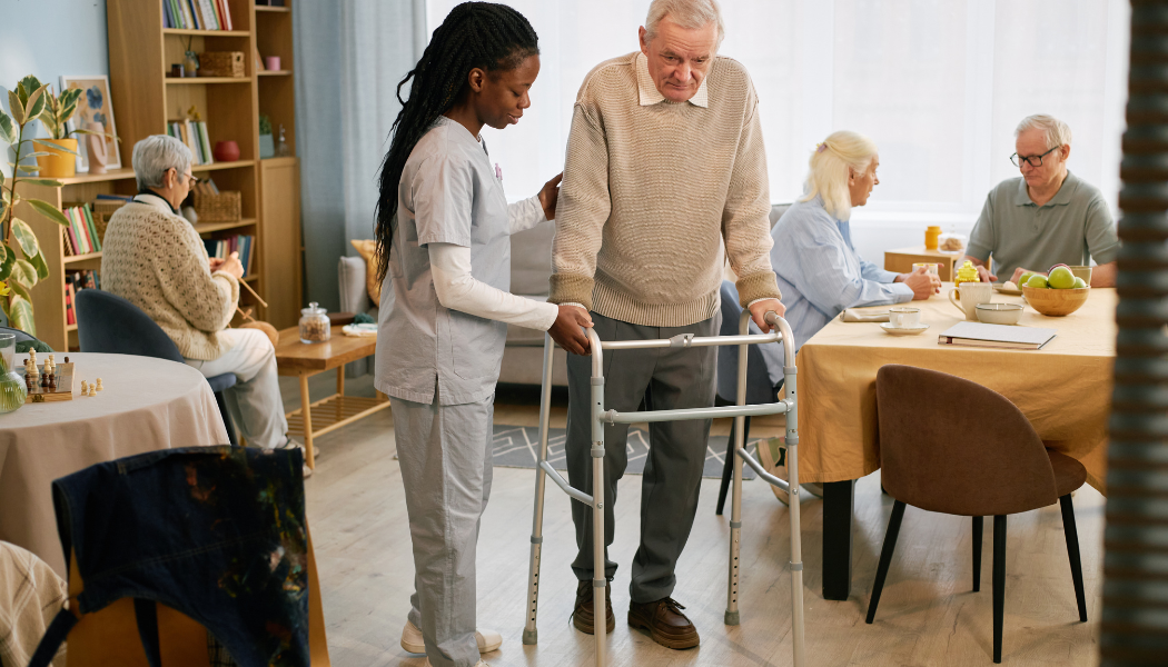 Nurse helps elderly patient with physical therapy