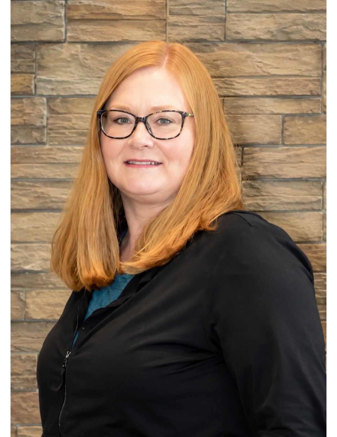 nurse with glasses in black scrubs 